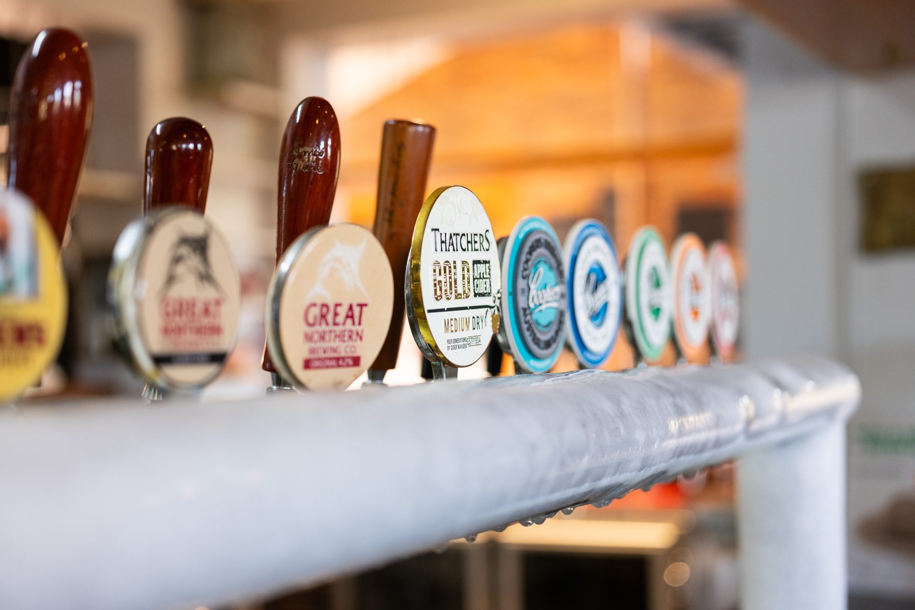 Beer taps lined up along the bar